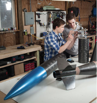 Students Working on Rocket in Garage