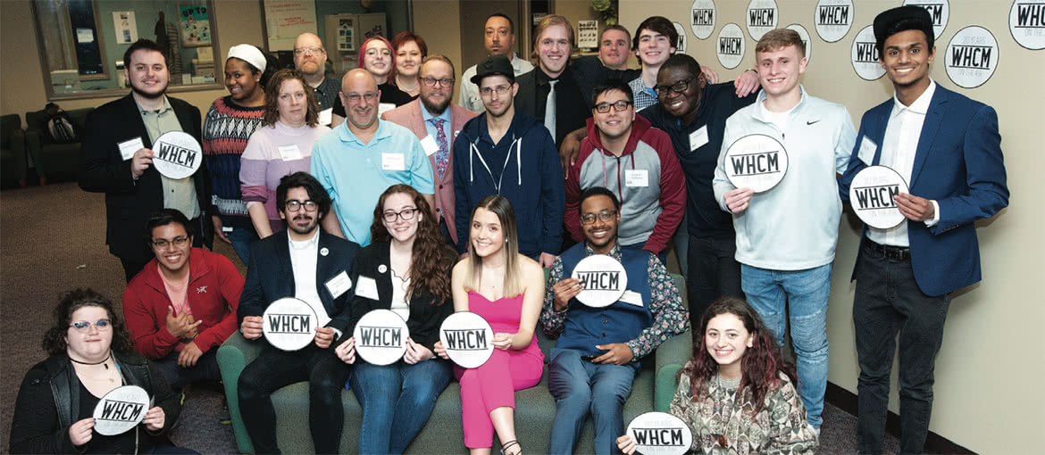 Group of students outside of the WHCM radio station