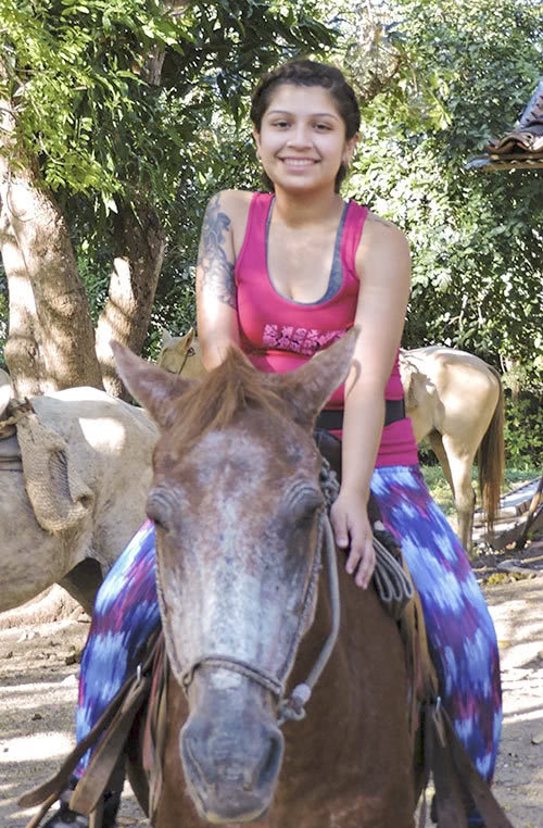 Jessica Flores riding a horse.