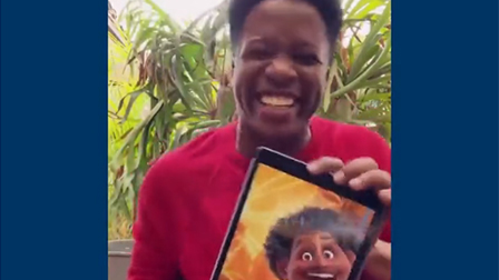 Mauro Castillo holds up an image of his character in Encanto.