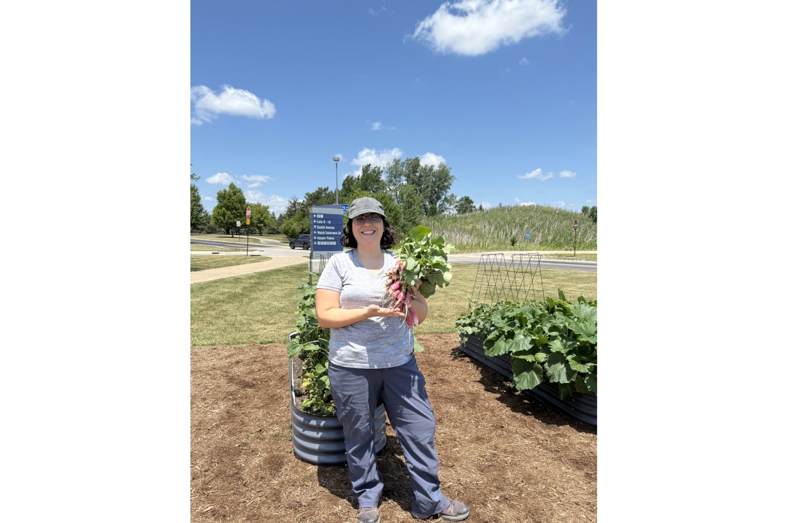 Harper Grows coordinator Ginger McHugh-Kurtz posing with a healthy bushel of beets grown in the garden