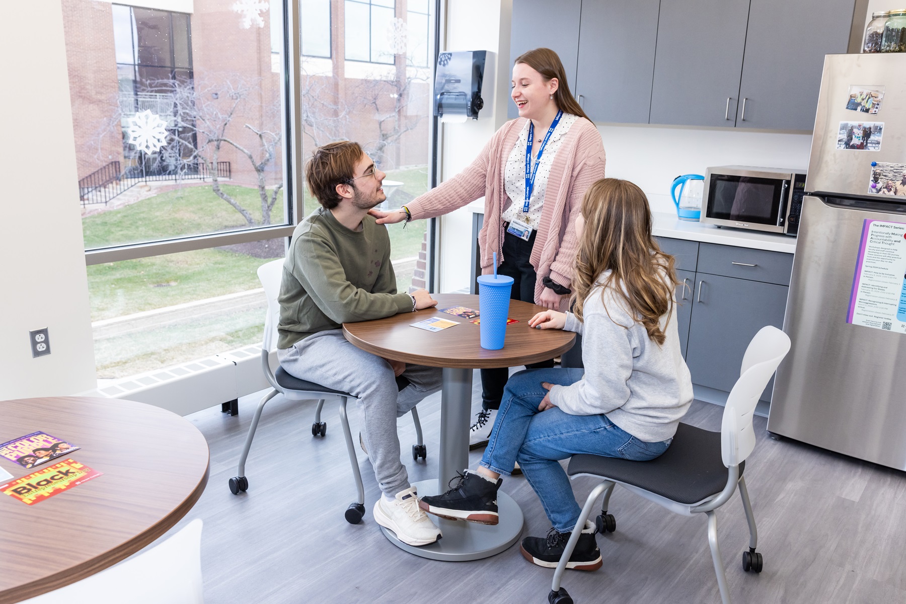 students sitting in small kitchen