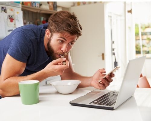 Person checking phone and laptop Photo of person checking cell phone and laptop