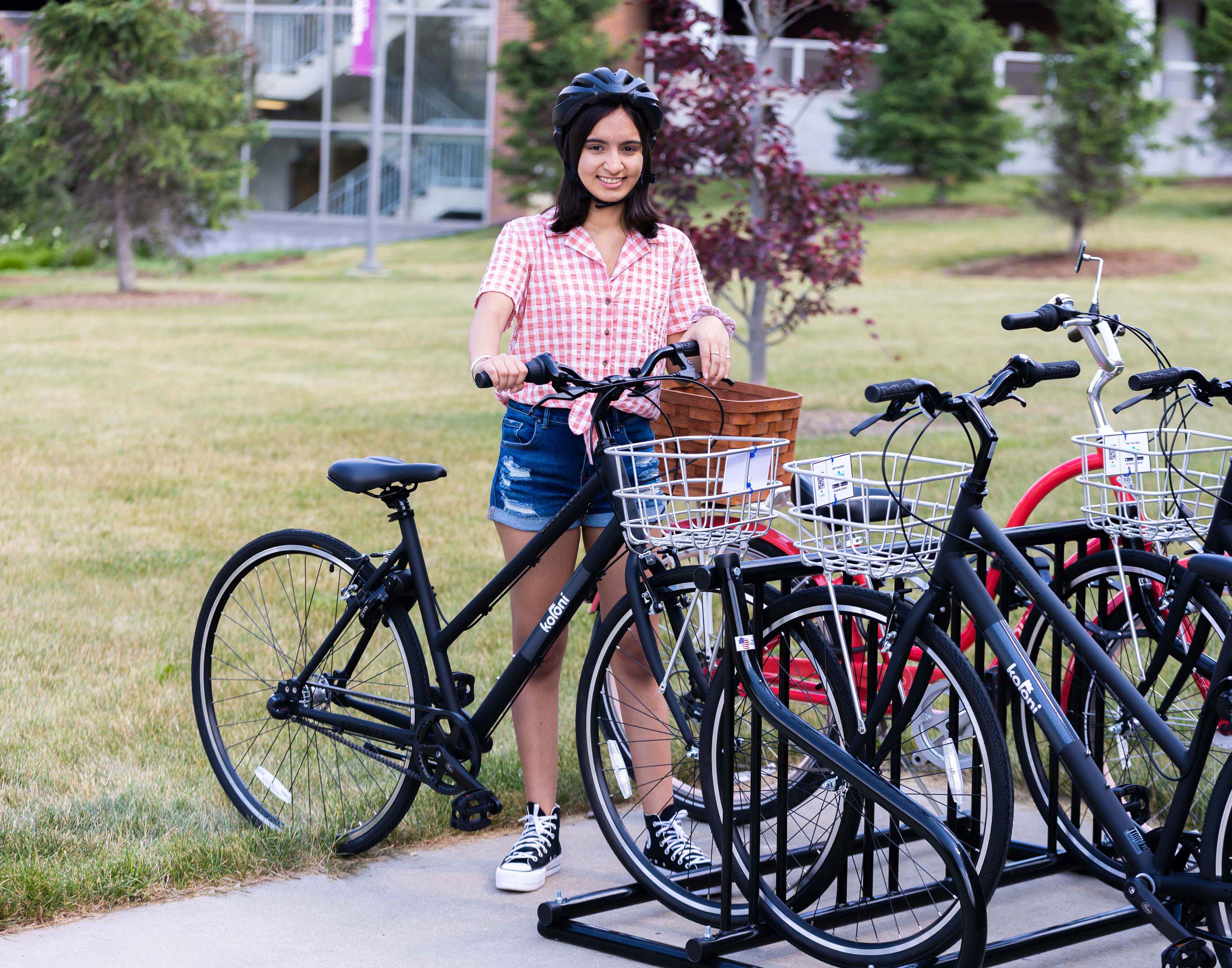 Woman standing next to a bike.