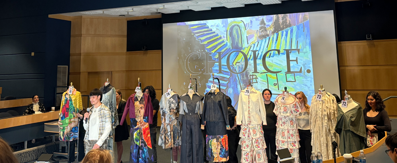 Student-designed garments on display during a fashion show presentation.