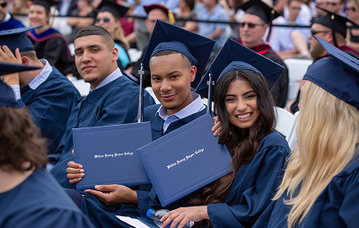 Students show of diplomas at graduation