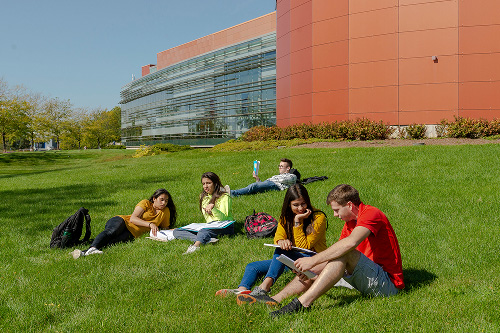 Students read on the grass in front of Avante