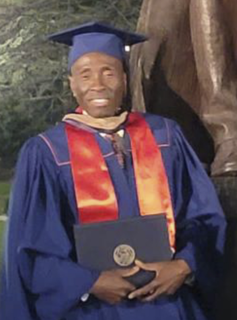 photo of Joshua Emeka Emeruem in graduation cap and gown
