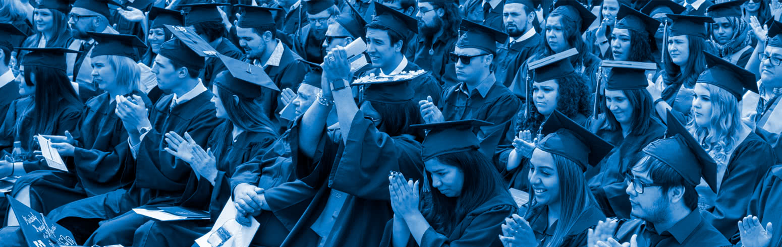 Graduates listening at graduation