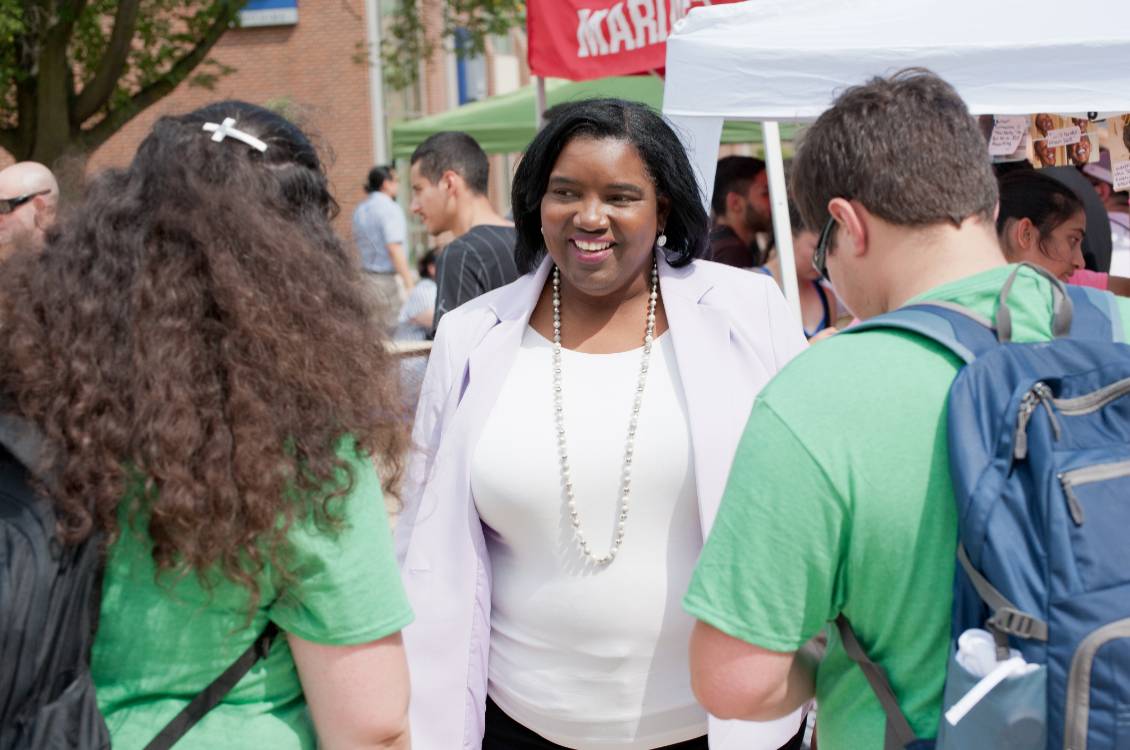 Dr. Proctor speaking with students at outdoor student event