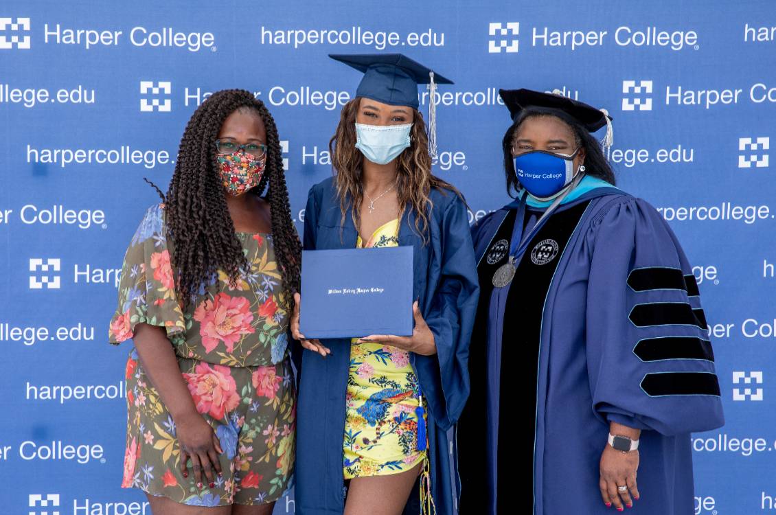Dr. Proctor with a Harper graduate and her guest.