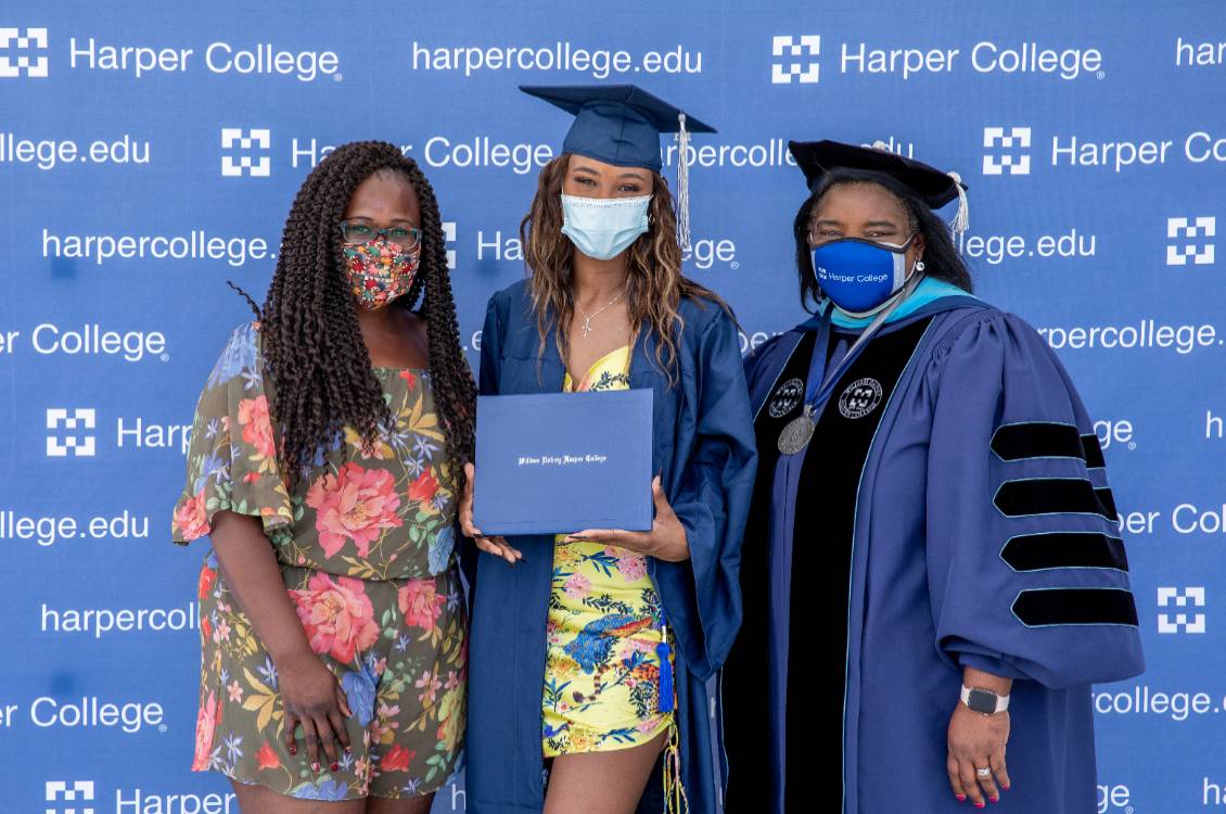 Dr. Proctor with a Harper graduate and her guest.