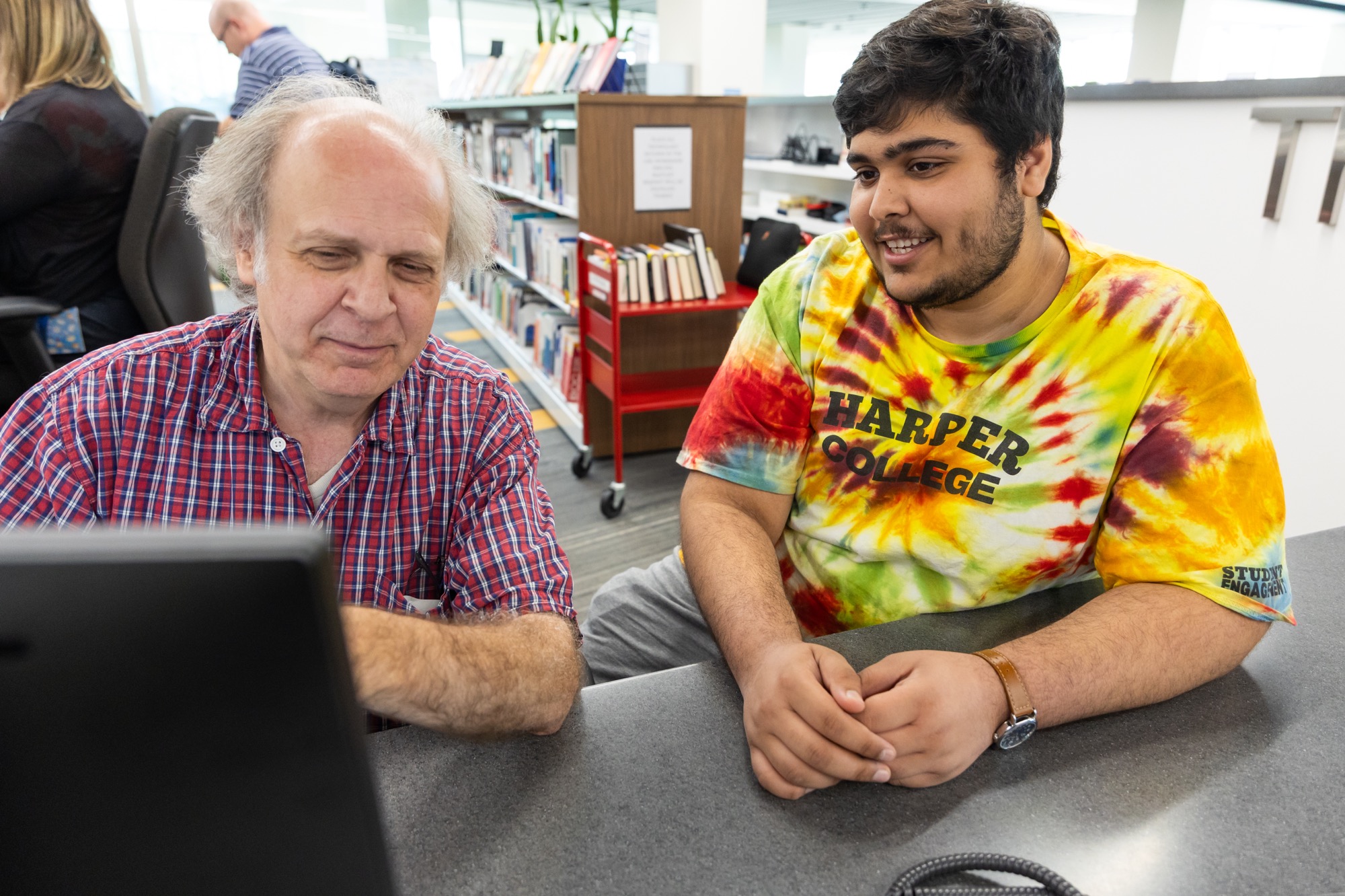 librarian and student sitting at a computer and discussing something