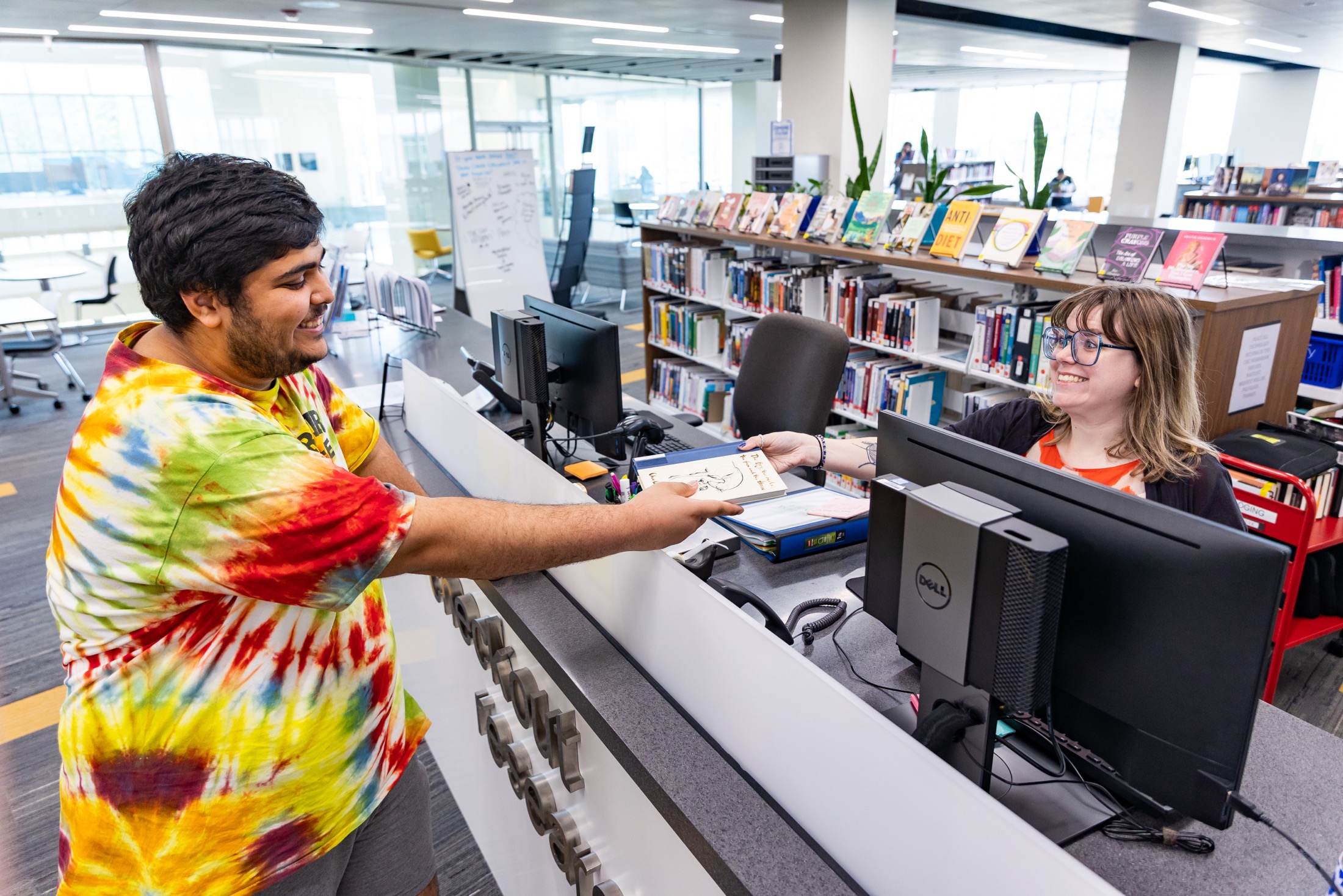 employee checking out a book