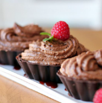 image of choclate mousse with a red raspberry ontop