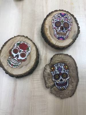 image of skull candy skeleton engraved on a piece of wood with laser cutter 