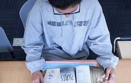 Student holds a book