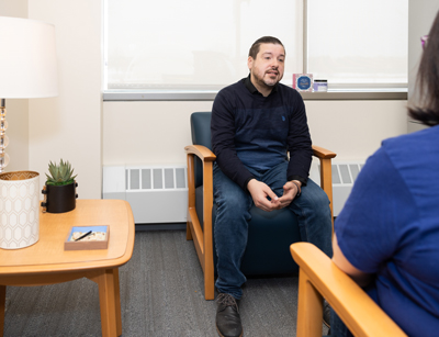 a counselor sitting and listening to a student