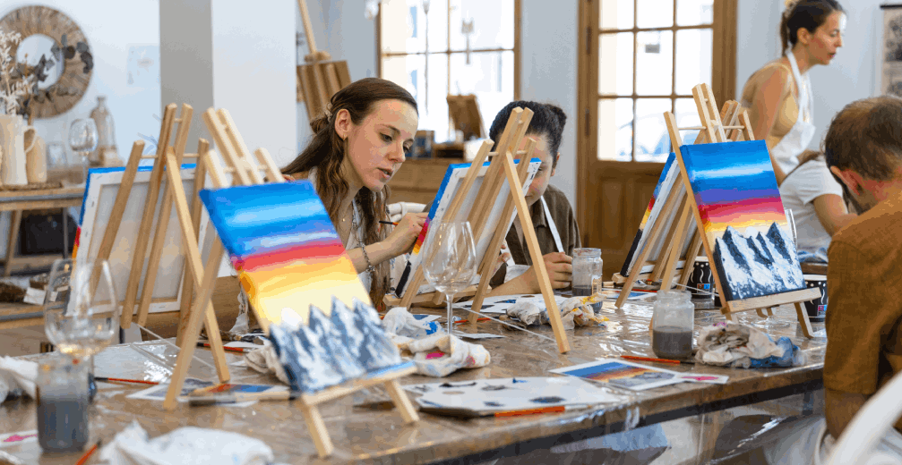 People painting landscapes in an art class