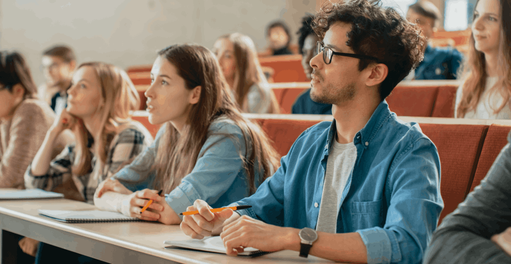 Adult college students listening attentively in a lecture hall