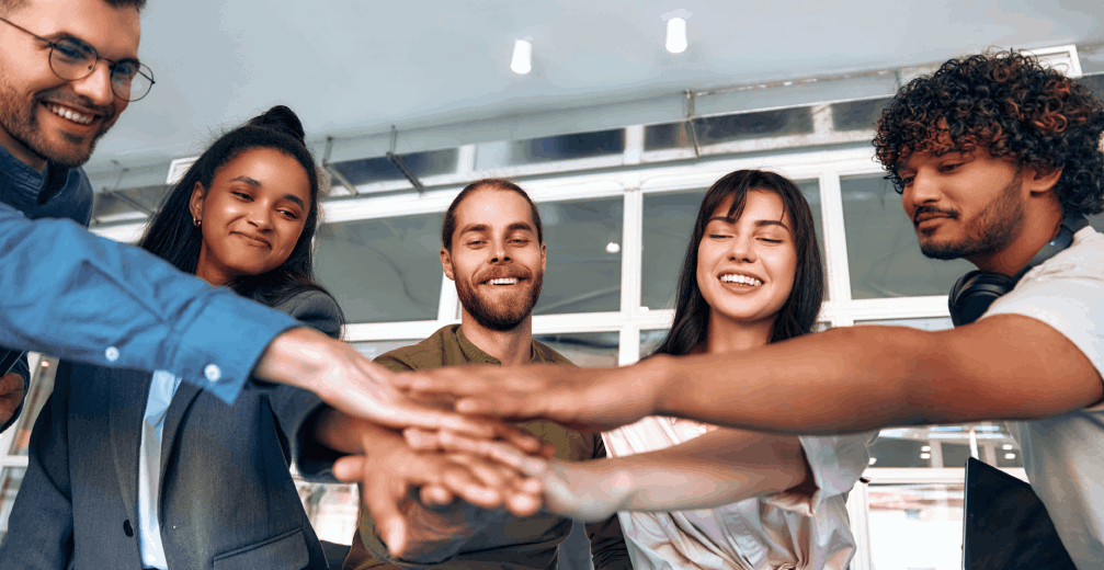 Group of young people touching hands.