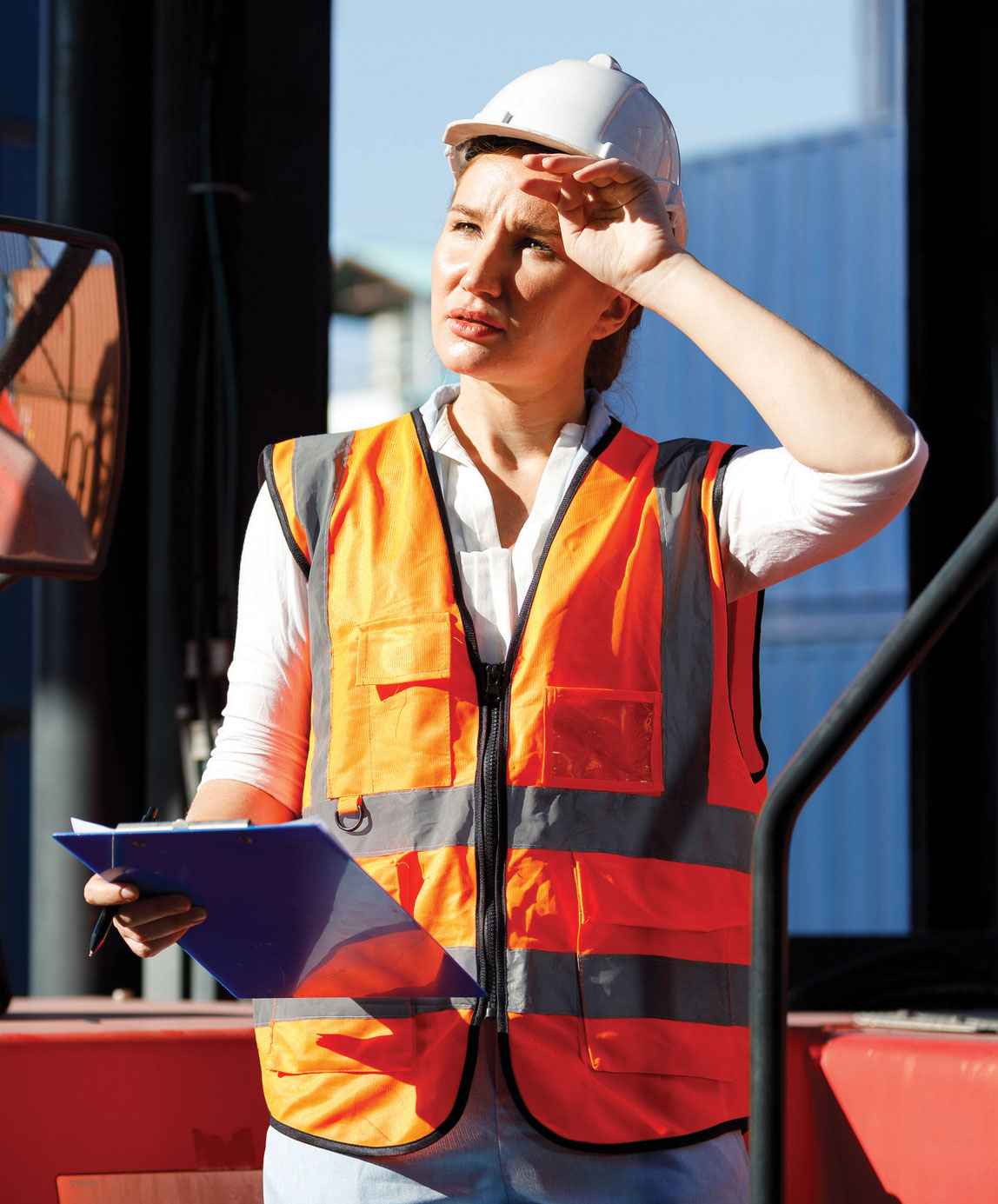 woman in construction vest struggles with the heat