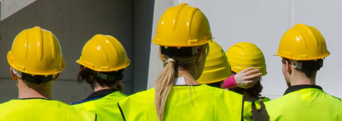 Workers wear safety hats.