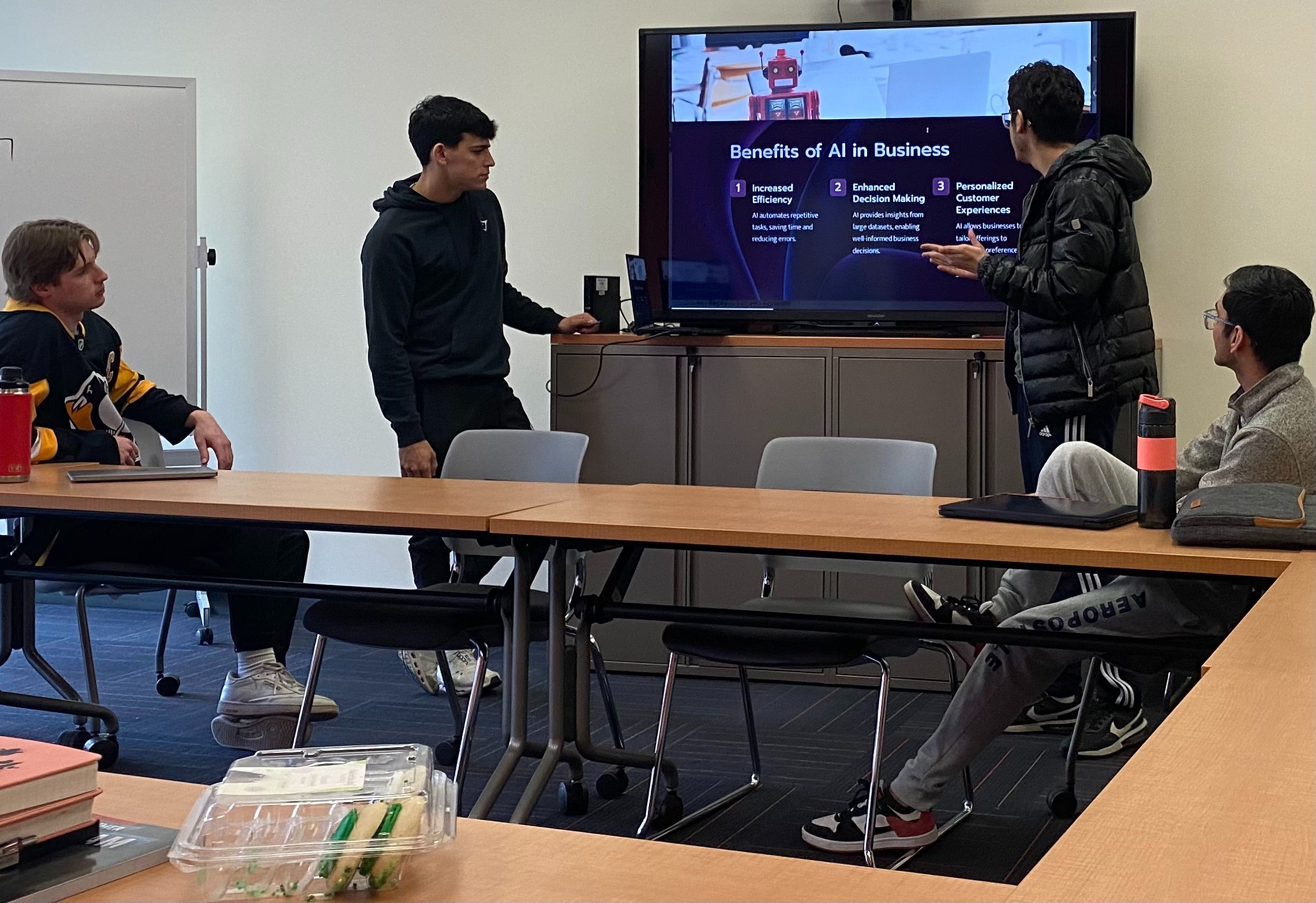 Students going over powerpoint at club meeting