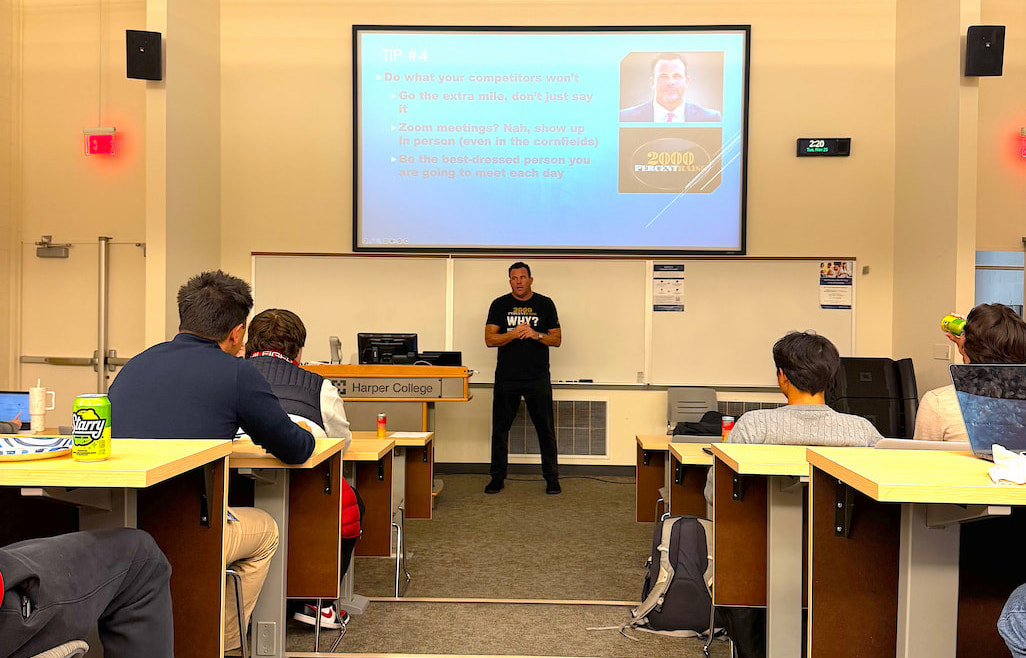 Guest speaker presenting to Harper College Business Club members in a classroom, with students seated and listening