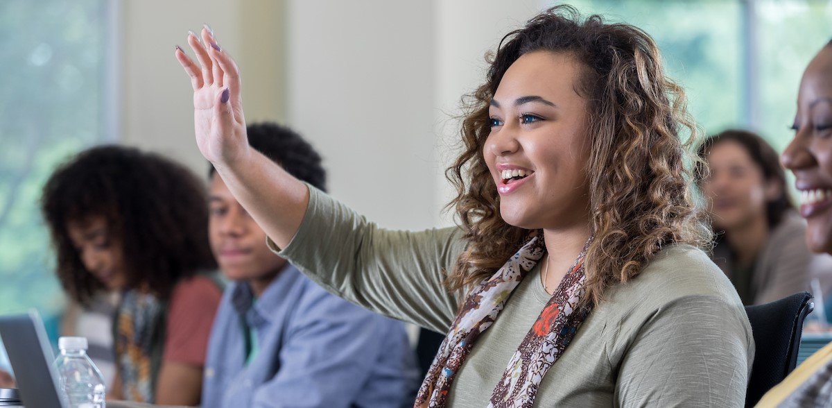 Student raising hand in class