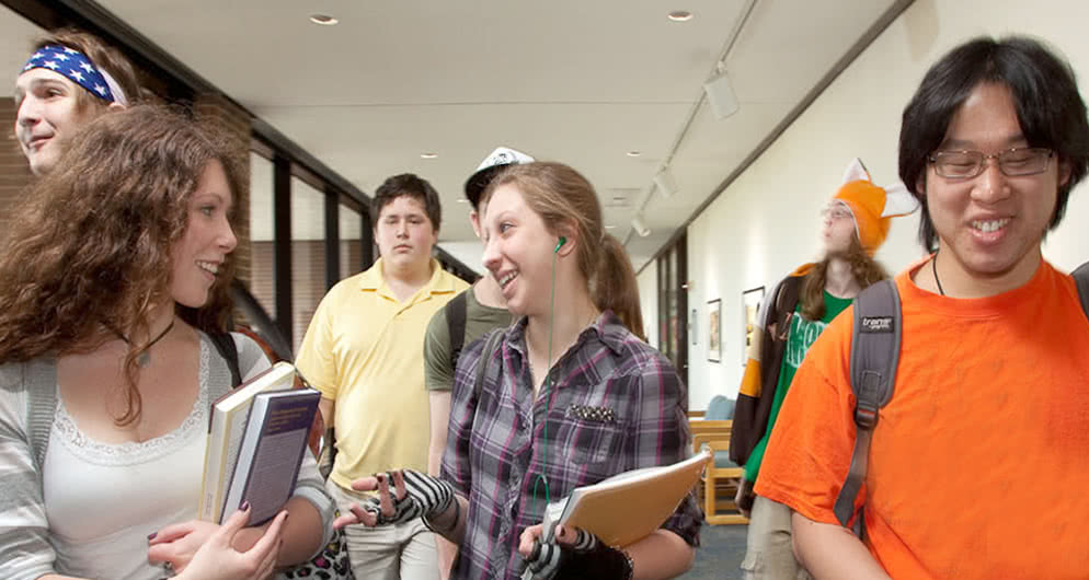 Students walk together after class, talking and smiling
