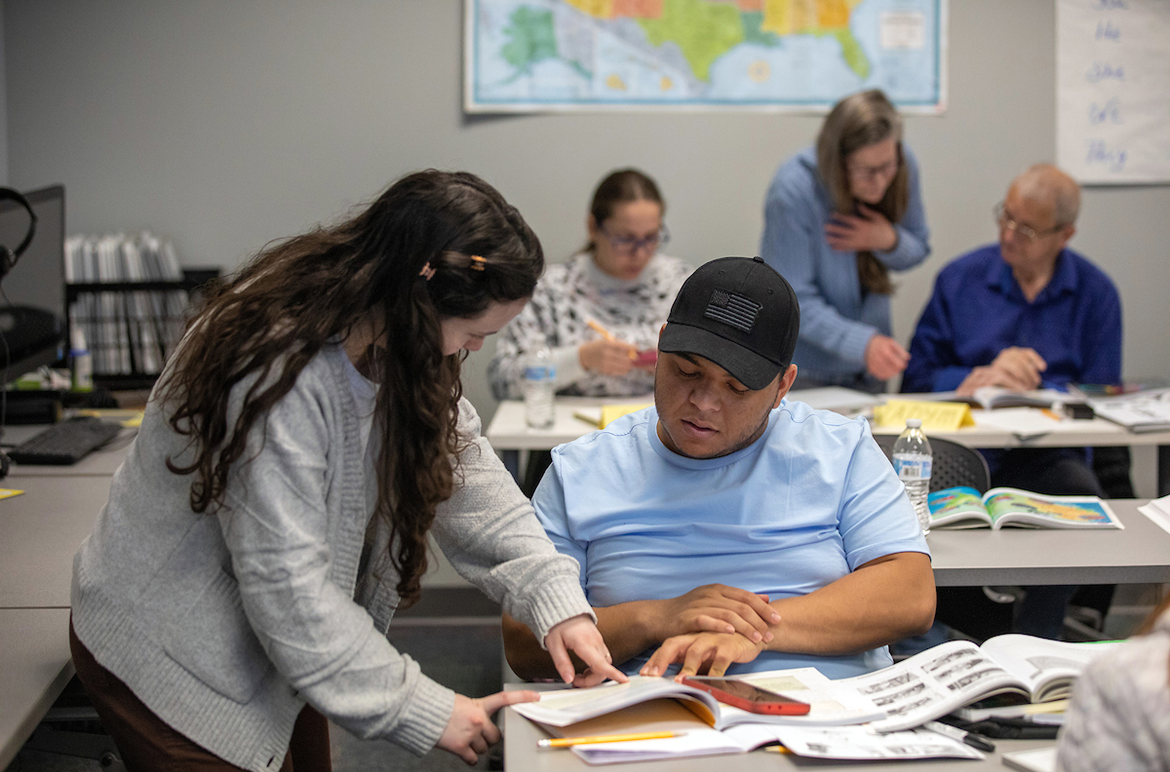 Students help each other in classroom