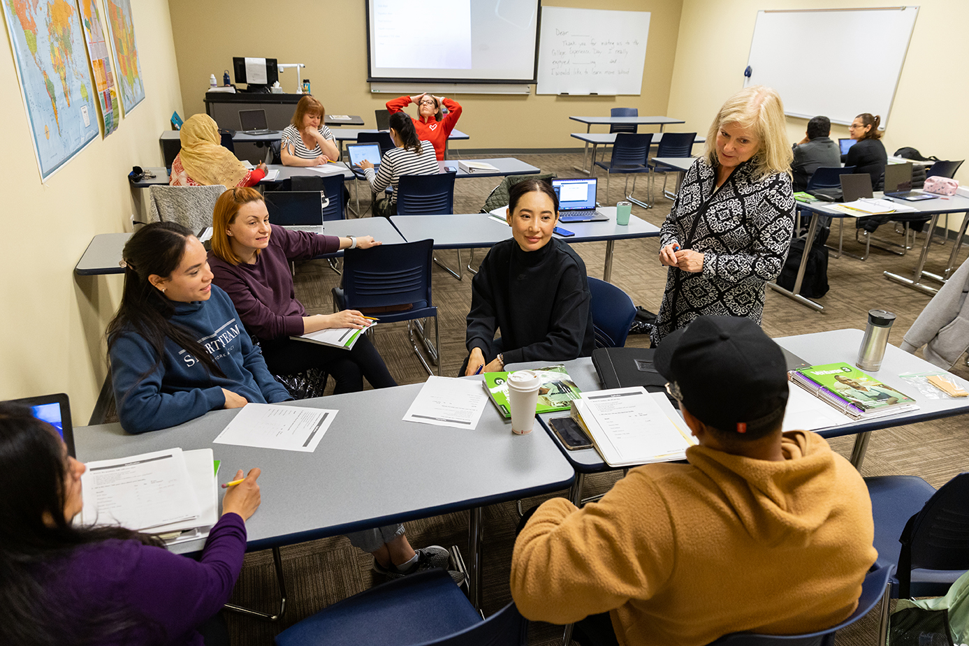 Students talk with a teacher