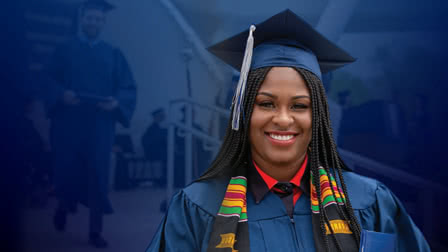Smiling adult student wearing a graduation cap and robes