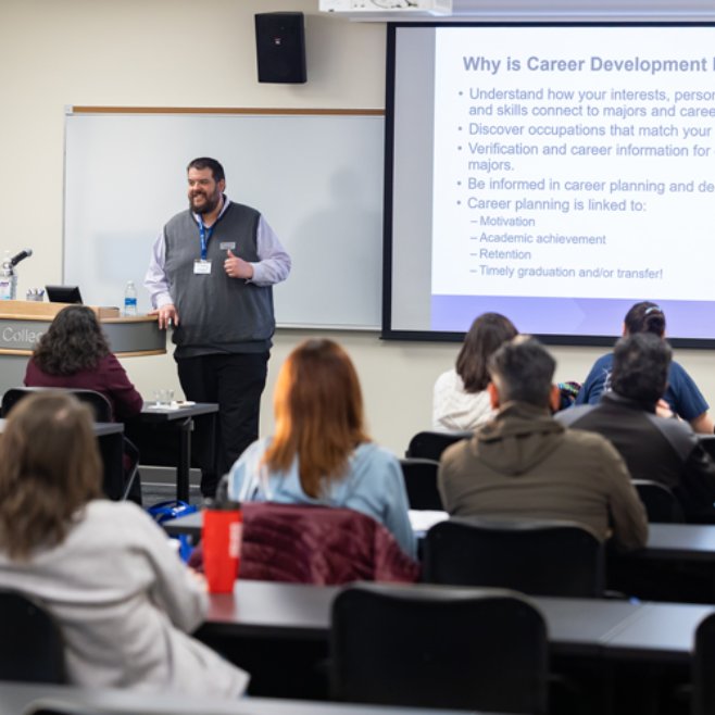 A lecturer stands in front of a projection screen at a Career Direction Workshop