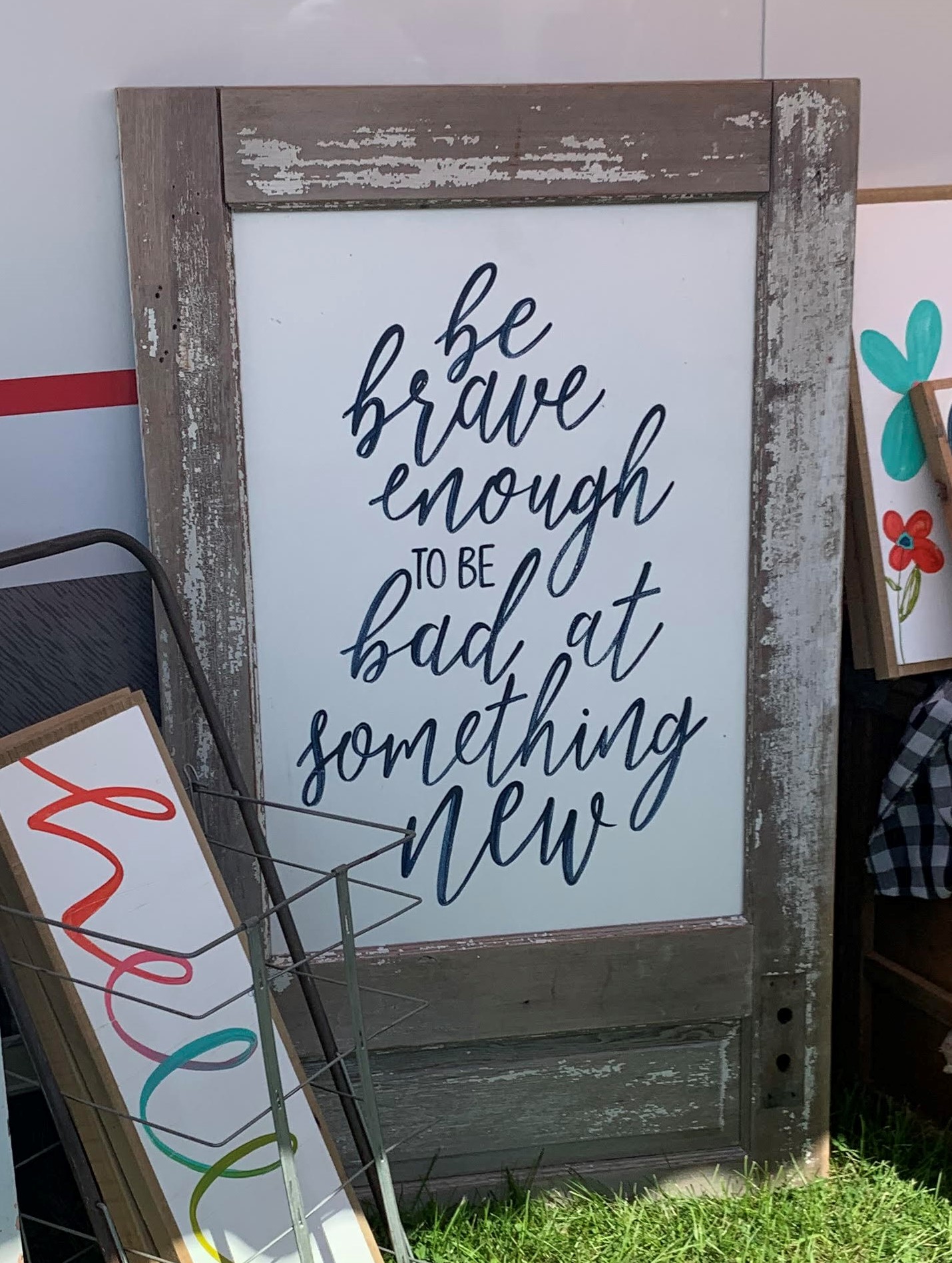 Photo of a door with the phrase, "Be brave enough to be bad at something new."