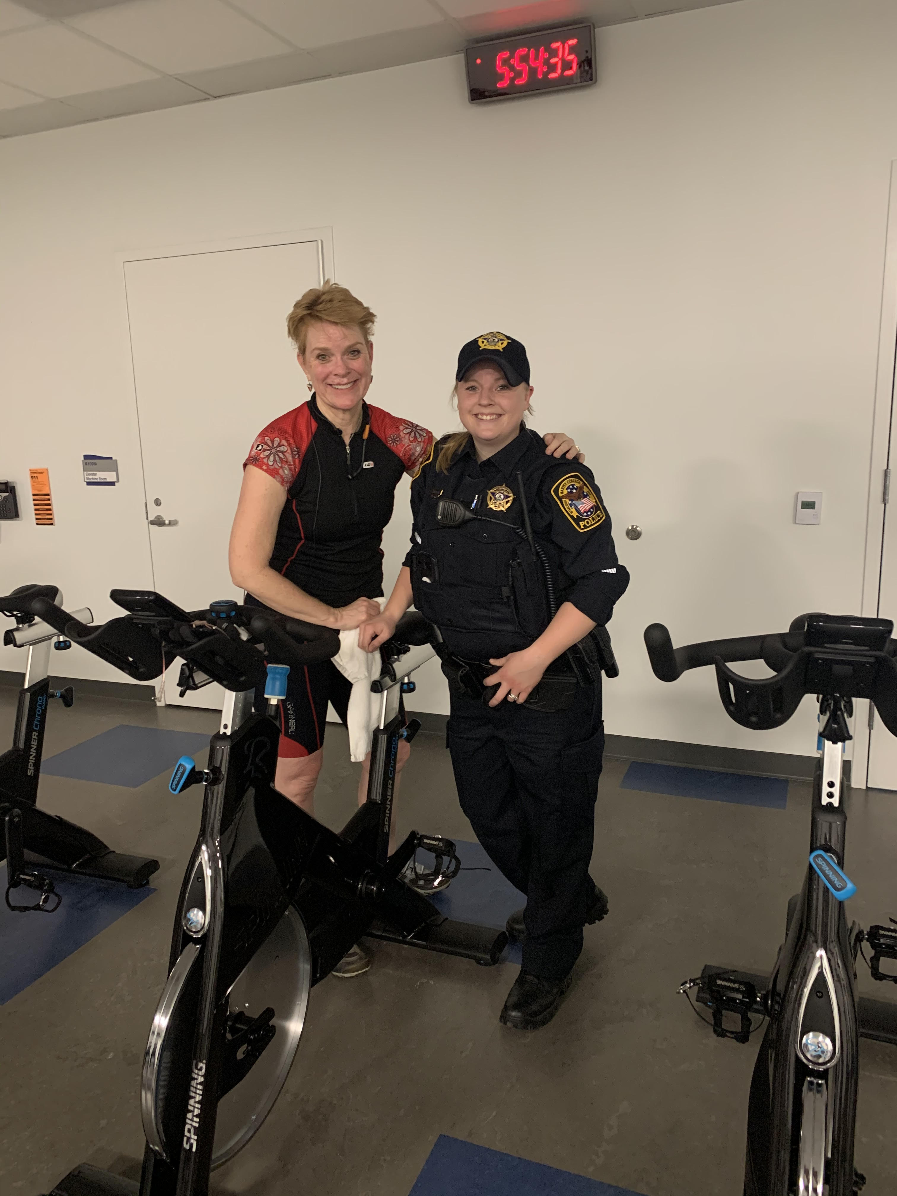 Photo of Mary Kay Harton and Melissa Harrah by a stationary bike.
