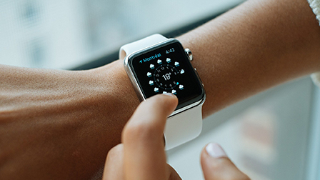 Photo of an apple watch on a wrist.