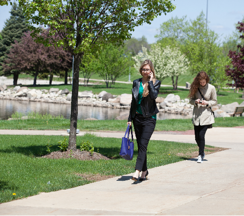student walking outside on cell phone