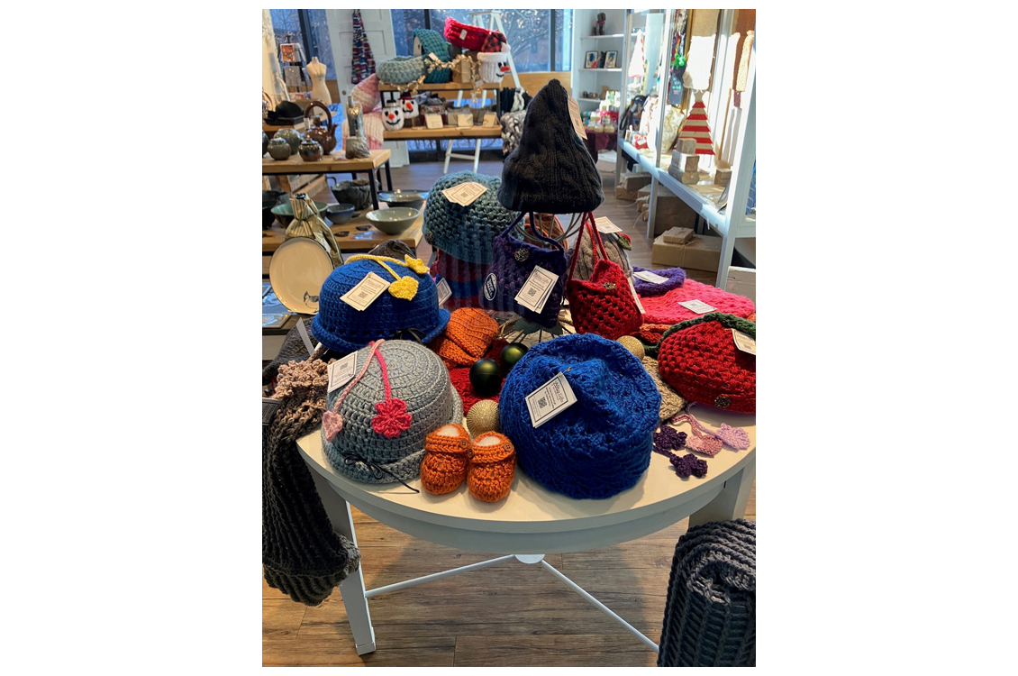 knitted hats and bags on display table