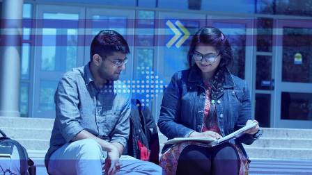 Students sitting on steps of Avante, reading a book