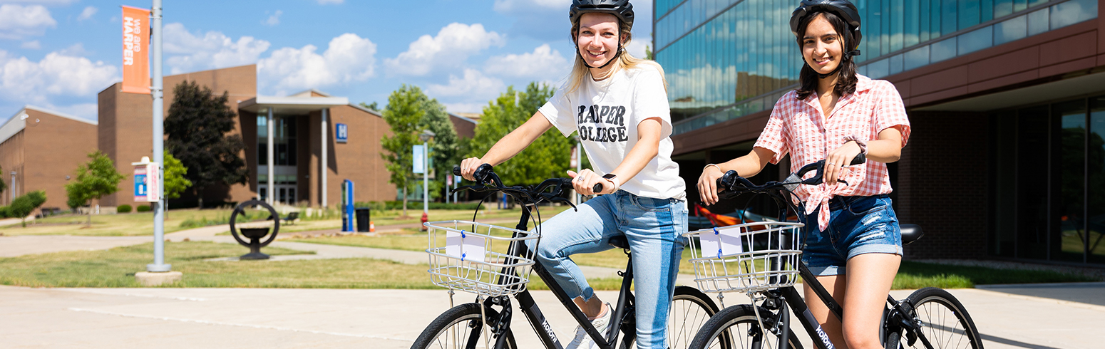 Students pose on bikes on Harper's campus.