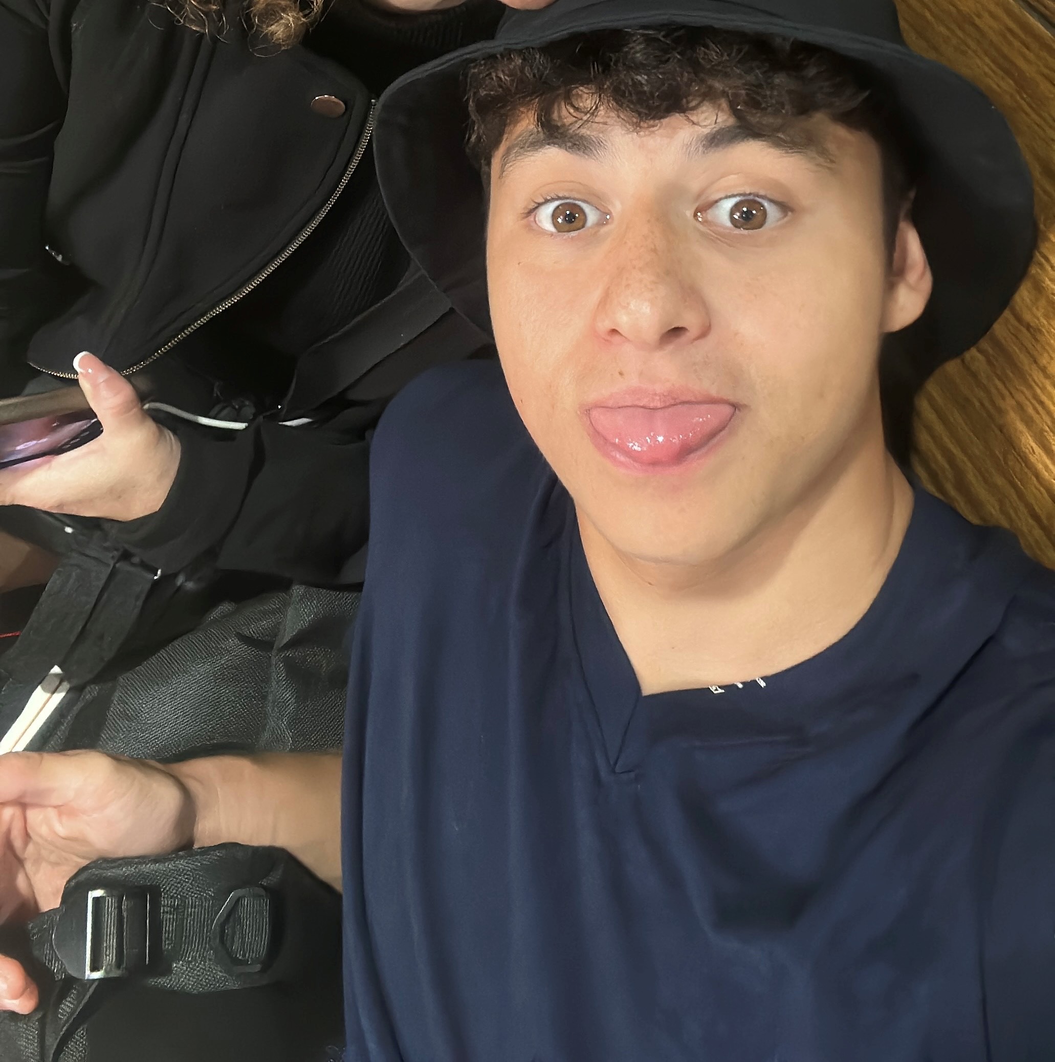 Photo of Ben with a hat on sticking out his tongue